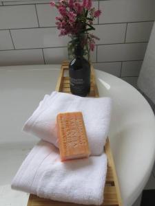 a soap sitting on top of towels on a bath tub at The Artist's Cottage in Bendigo