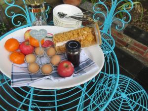 a plate of fruit and eggs on a table at The Artist's Cottage in Bendigo