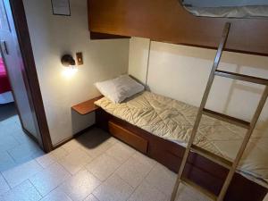 a small room with a bunk bed and a ladder at Pousada do Serrano - Rua Torta in Gramado
