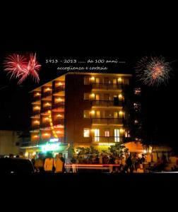 a building with fireworks in front of it at night at HOTEL RISTORANTE DELLE VALLI in Germagnano