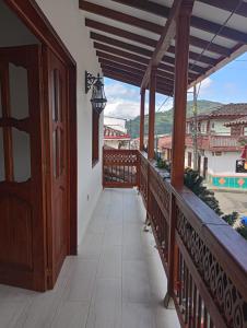 a wooden balcony with a view of a city at Hostal Famihotel Fundadores in Jardin