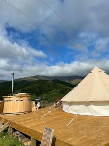 a large white tent sitting on top of a wooden deck at Studholme Glamping in Hunter