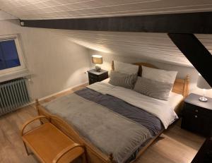 a bedroom with a large bed and two night stands at Ihr Zuhause im Herzen von Baden in Dielheim