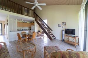 a living room with a table and a dining room at Takanoha Condo in Kahuku
