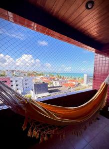 hamaca en una habitación con ventana grande en Bessa Beach Inn Ideal para Famílias, en João Pessoa