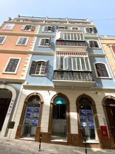 a blue building with a bunch of windows at Grand Central House - Luxe Penthouse Two Bedroom - GibraltarStay Apartments in Gibraltar