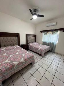 Ένα ή περισσότερα κρεβάτια σε δωμάτιο στο Flores Condominios Casa Narciso