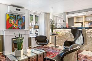 a living room with a fireplace and a painting on the wall at Best Western Hotel Anno 1937 in Kristianstad