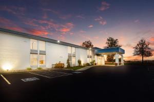 a large white building with a parking lot at SureStay Plus Hotel by Best Western Jasper in Jasper