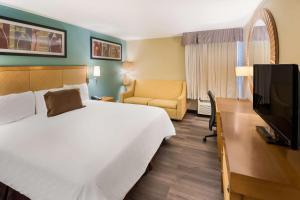 a hotel room with a large bed and a television at SureStay Plus Hotel by Best Western Jasper in Jasper