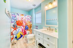 a bathroom with a toilet and a shower curtain at Seashore's Best in North Topsail Beach +39 photos