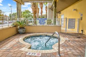 a hot tub in a courtyard with a sign on a building at Harbourgate Marina Club in Myrtle Beach