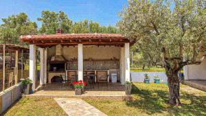 a gazebo with a fireplace in a yard at Bella Mare Villa Sithonia in Akti Salonikiou