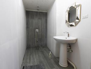 a bathroom with a sink and a mirror at Castara Cottage by Hello Mello in Castara