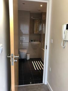 a bathroom with a toilet and a bath tub at STUDIO Apartment opposite shoreditch Park in London