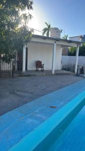 a swimming pool in front of a house at Flores Condominios Depa Lili in Álamos