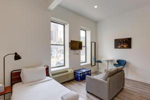 a bedroom with a bed and a chair at Ground Floor Studios in Chicago by 747 Lofts in Chicago