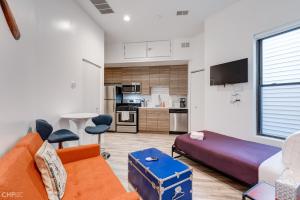 a living room with a couch and a bed at River West, Third Floor Chicago by 747 Lofts in Chicago