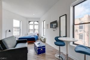 a living room with a couch and a table at Chicago Third Floor Studio by 747 Lofts in Chicago