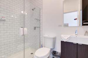 a bathroom with a toilet and a sink and a shower at Chicago Third Floor Studio by 747 Lofts in Chicago