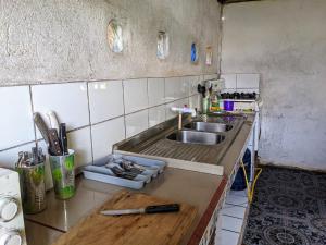 a kitchen with a sink and a wooden counter top at La Katalinda in Drake