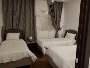 ein Hotelzimmer mit zwei Betten und einem Fenster in der Unterkunft Schone, ruhige neuwertige, 127 qm Fewo in Sidi Daoud