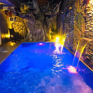 a pool in a cave with a water feature at Winterfell Cafe and Private Resort in Bacolod