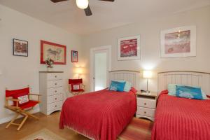 a bedroom with two beds and a chair at 1460 Strand Way in Oceano