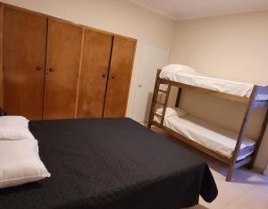 a bedroom with two bunk beds and a closet at Privilegio Hostel in San Rafael