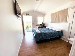 a bedroom with a bed and a television in it at Warrego Hotel Motel Cunnamulla in Cunnamulla