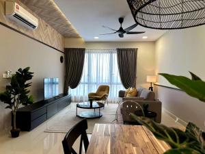 a living room with a couch and a table at The Apple Premier Condo in melaka in Melaka