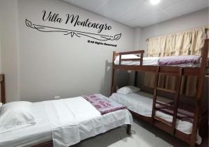 a bedroom with two bunk beds and a sign that readsilla manabase at Habitación privada en Salinas in Salinas