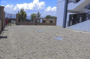 a courtyard of a white building with a fence at Devine Studio in Naivasha Town in Naivasha