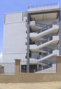 a white apartment building with stairs in front of it at Devine Studio in Naivasha Town in Naivasha