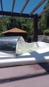 a water fountain in a park with a umbrella at Chalé Recanto dos Sonhos in Campina Grande do Sul