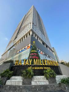 a tall building with a christmas tree in front of it at TSQ STAY Hotel Apartment in Hanoi