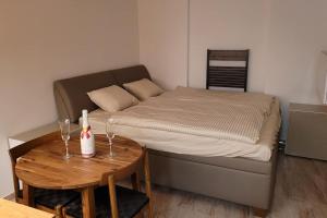 a small bedroom with a bed and a table at Luxusní apartmán nedaleko centra in Prague
