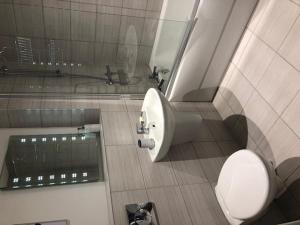 a bathroom with a toilet and a sink at Brooklands Hideaway in Scarborough +18 photos
