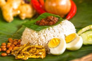 a plate of food with rice and eggs and nuts at SANKARA GARDEN in Pantai