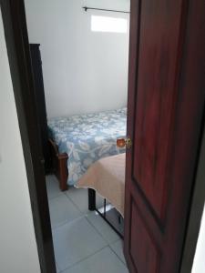 a door leading into a room with a small bed at hotel Valery in San Gil