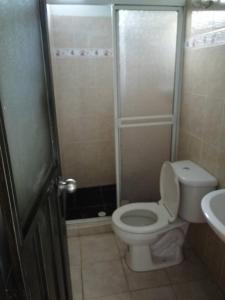 a bathroom with a toilet and a shower and a sink at hotel Valery in San Gil