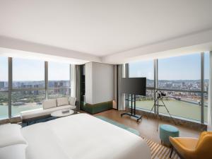 a bedroom with a bed and a view of a city at Hyatt Place Nanchong Gaoping in Nanchong