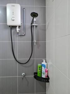 a shower in a bathroom with a blow dryer at 3Storey House 13Pax Family Suite in Bayan Lepas