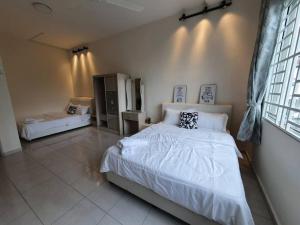 a bedroom with a large bed with white sheets at 3Storey House 13Pax Family Suite in Bayan Lepas