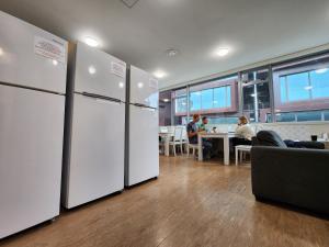 オークランドにあるNewton Lodge Aucklandの白い冷蔵庫が備わる客室で、テーブルに座る人数が含まれます。