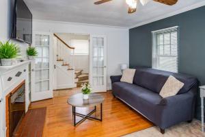a living room with a blue couch and a table at ~Hot Tub~ in a Quiet Home near UofR/Dwnt/Aiprt/RIT in Rochester