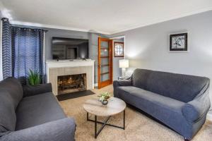 a living room with two couches and a fireplace at Astonishing Home Mins Away Airport/Dwtn/UofR/RIT in Rochester