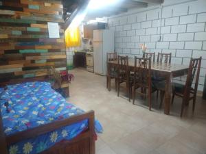 a kitchen and dining room with a table and chairs at cabañas rio y playa 2 in Atos Pampa