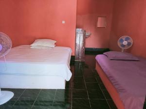 Perwita Homestay客房内的一张或多张床位