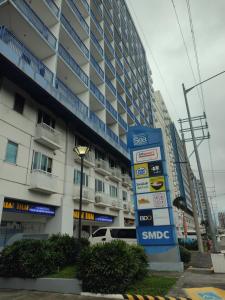 a snide gas station in front of a building at Sea Residences MOA Complex - Ruffa's Condotel in Manila